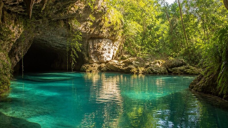 Empty cenote lagoon at 8 a.m. with morning light on the water