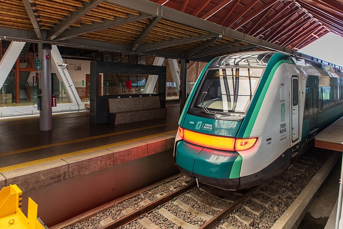 Modern Tren Maya train alongside lush Yucatan jungle